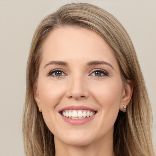 Joyful white young-adult female with long  brown hair and green eyes