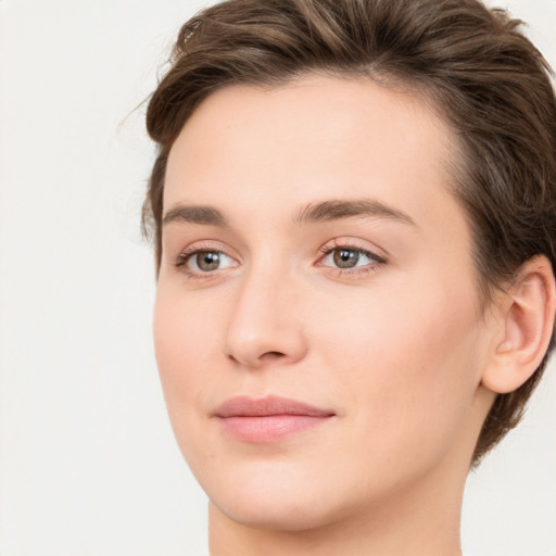 Joyful white young-adult female with long  brown hair and green eyes