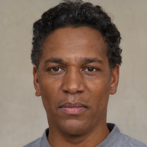 Neutral black adult male with short  black hair and brown eyes
