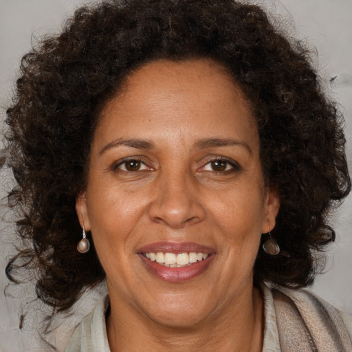 Joyful black adult female with medium  brown hair and brown eyes
