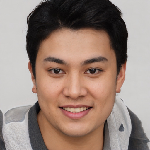 Joyful asian young-adult male with short  brown hair and brown eyes