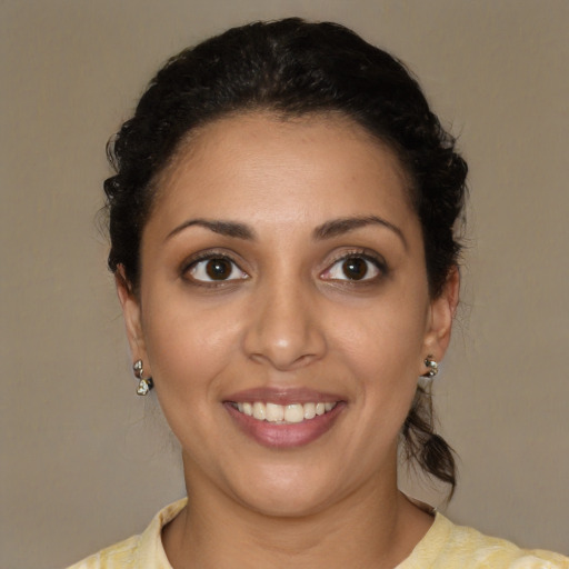 Joyful latino young-adult female with medium  brown hair and brown eyes