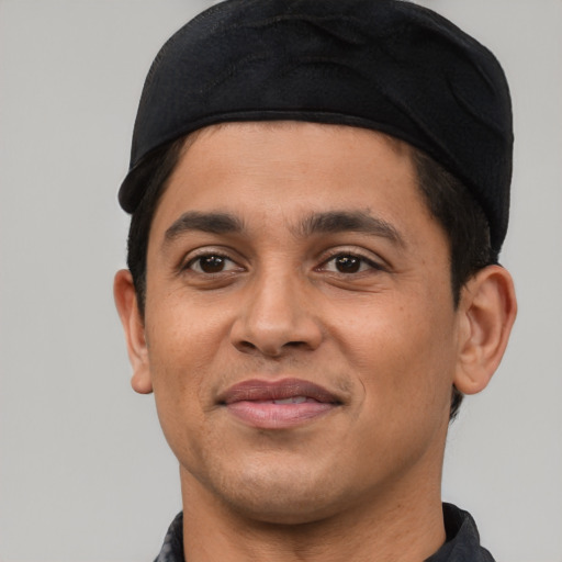 Joyful latino young-adult male with short  black hair and brown eyes