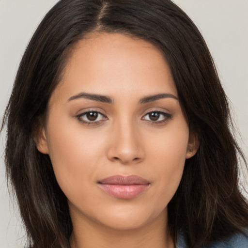 Joyful latino young-adult female with long  brown hair and brown eyes