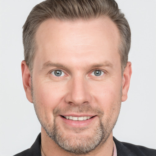 Joyful white adult male with short  brown hair and grey eyes