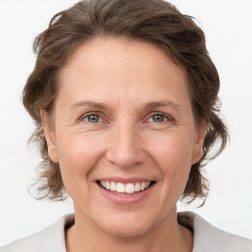 Joyful white adult female with medium  brown hair and grey eyes