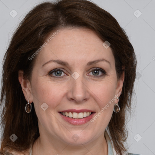 Joyful white adult female with medium  brown hair and grey eyes