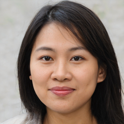 Joyful asian young-adult female with long  brown hair and brown eyes
