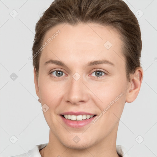 Joyful white young-adult female with short  brown hair and grey eyes