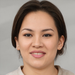 Joyful asian young-adult female with medium  brown hair and brown eyes