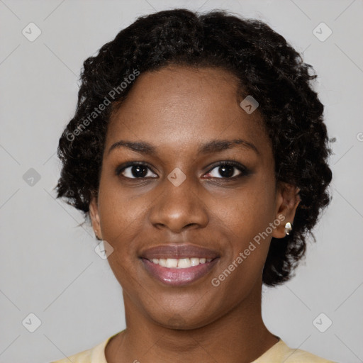 Joyful black young-adult female with short  brown hair and brown eyes