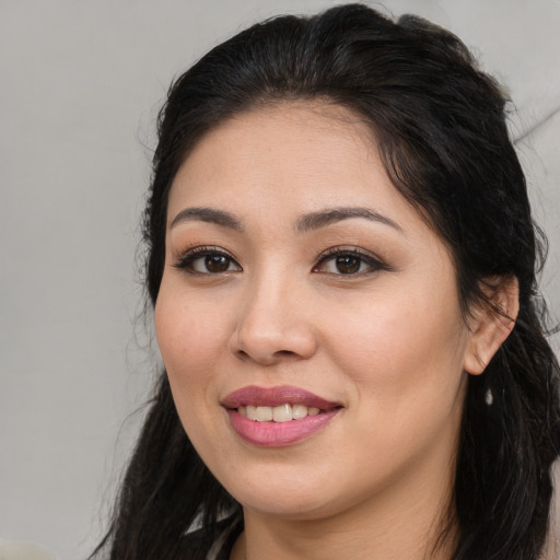 Joyful white young-adult female with long  black hair and brown eyes