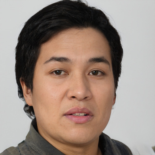 Joyful asian young-adult female with short  black hair and brown eyes