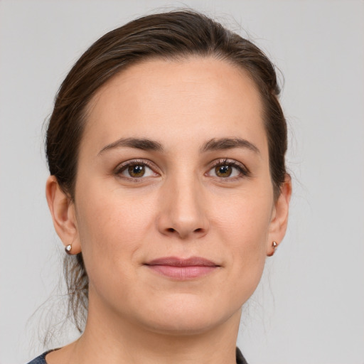 Joyful white young-adult female with medium  brown hair and grey eyes