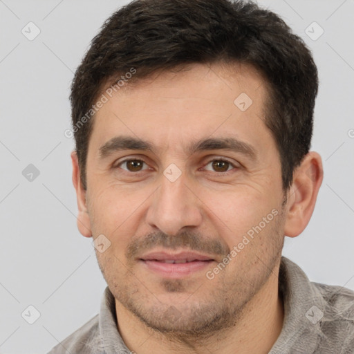 Joyful white adult male with short  brown hair and brown eyes