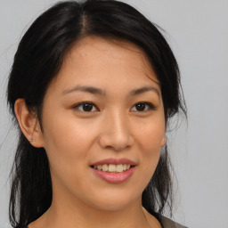 Joyful asian young-adult female with medium  brown hair and brown eyes