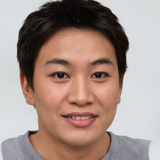 Joyful asian young-adult female with short  brown hair and brown eyes