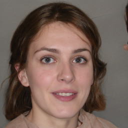 Joyful white young-adult female with medium  brown hair and blue eyes