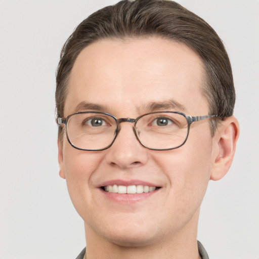 Joyful white adult male with short  brown hair and brown eyes