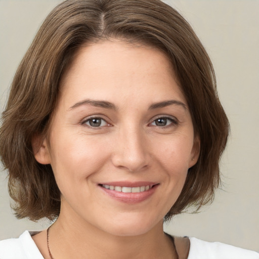 Joyful white young-adult female with medium  brown hair and brown eyes