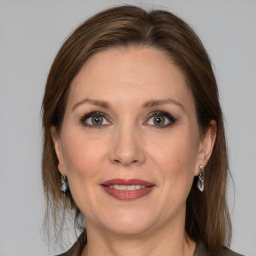 Joyful white adult female with medium  brown hair and grey eyes