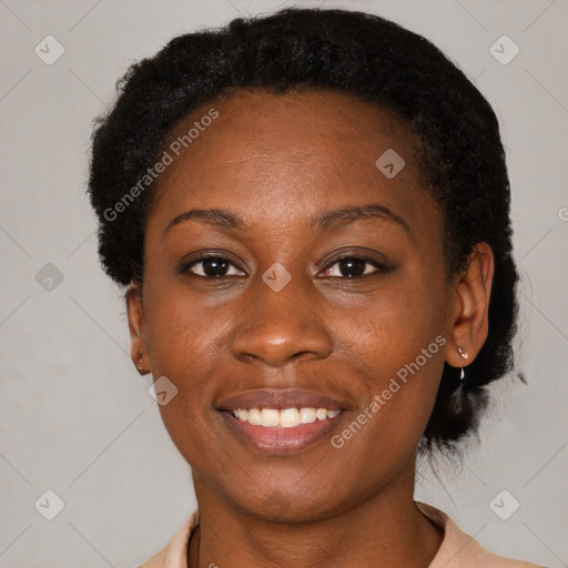 Joyful black young-adult female with short  brown hair and brown eyes