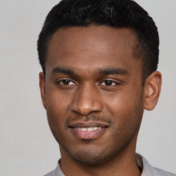 Joyful black young-adult male with short  brown hair and brown eyes