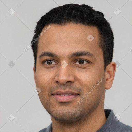 Joyful latino young-adult male with short  black hair and brown eyes