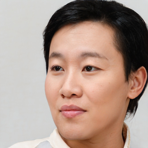 Joyful asian young-adult female with short  brown hair and brown eyes