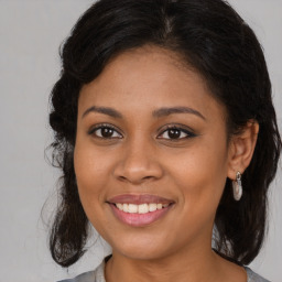 Joyful black young-adult female with medium  brown hair and brown eyes