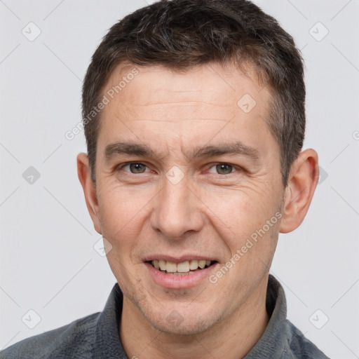 Joyful white adult male with short  brown hair and brown eyes