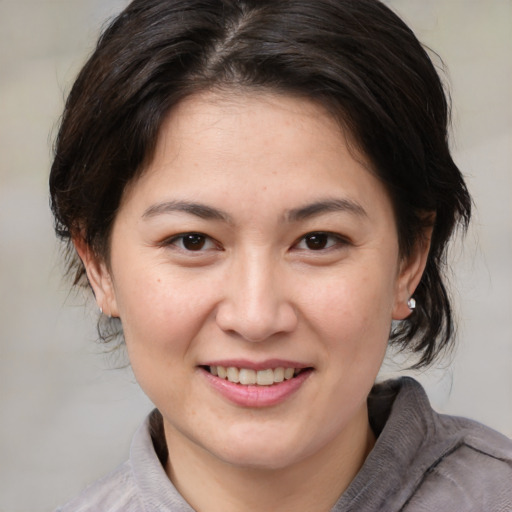 Joyful white young-adult female with medium  brown hair and brown eyes