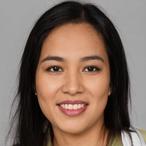 Joyful asian young-adult female with long  brown hair and brown eyes