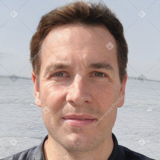 Joyful white adult male with short  brown hair and grey eyes