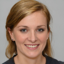 Joyful white young-adult female with medium  brown hair and blue eyes