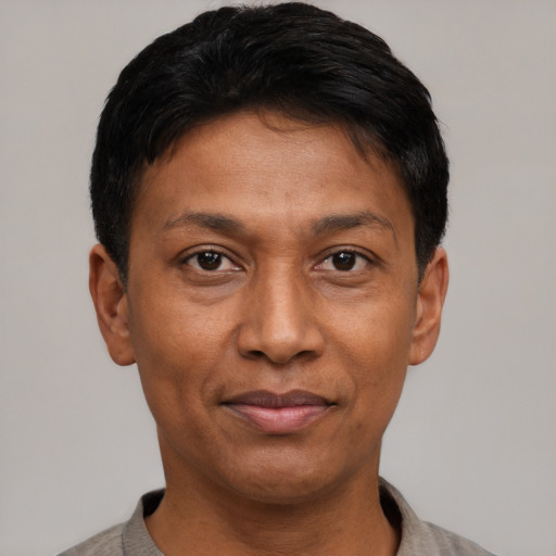 Joyful latino adult male with short  black hair and brown eyes