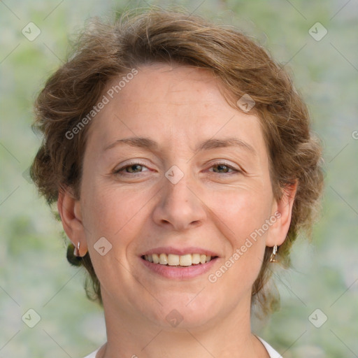 Joyful white adult female with medium  brown hair and green eyes