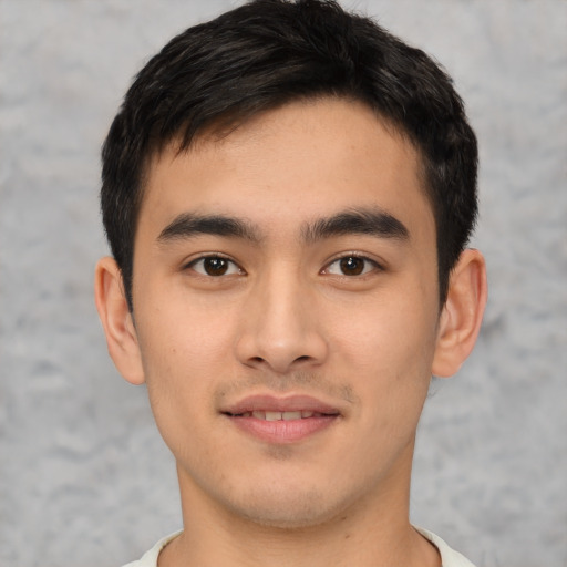 Joyful asian young-adult male with short  brown hair and brown eyes