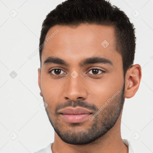 Neutral latino young-adult male with short  black hair and brown eyes