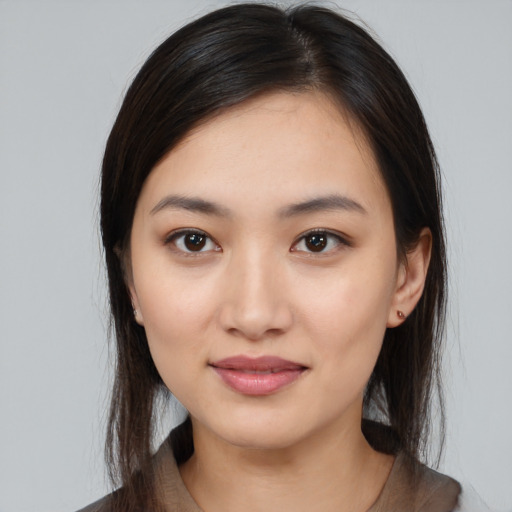Joyful white young-adult female with medium  black hair and brown eyes