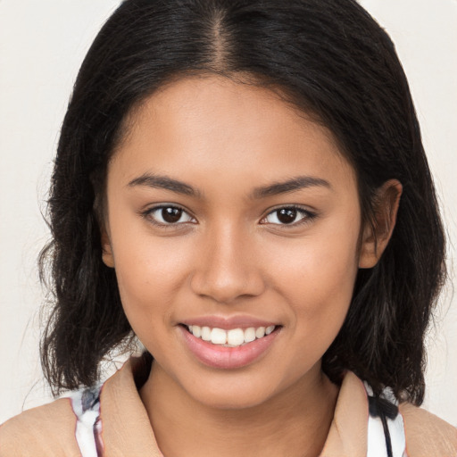 Joyful latino young-adult female with long  brown hair and brown eyes