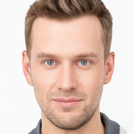 Joyful white young-adult male with short  brown hair and grey eyes