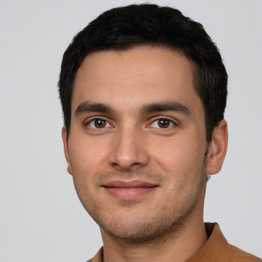 Joyful white young-adult male with short  black hair and brown eyes