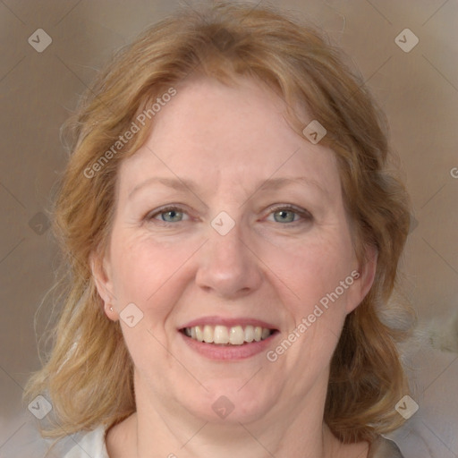 Joyful white adult female with medium  brown hair and blue eyes