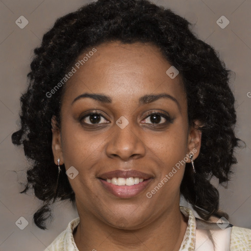 Joyful black adult female with medium  brown hair and brown eyes