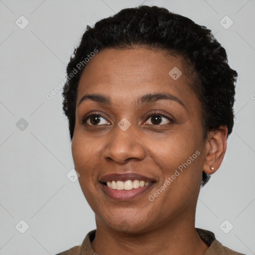 Joyful black young-adult female with short  black hair and brown eyes