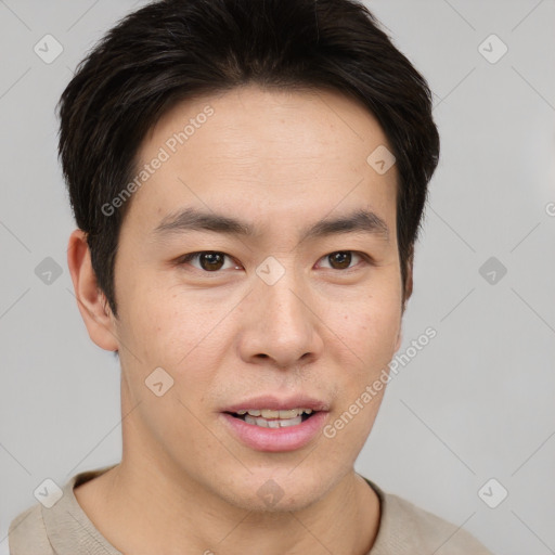 Joyful asian young-adult male with short  brown hair and brown eyes