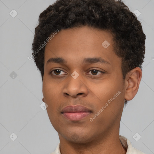 Joyful black young-adult male with short  brown hair and brown eyes