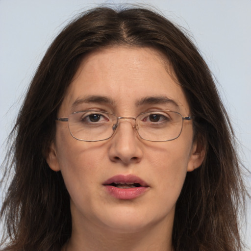 Joyful white adult female with long  brown hair and brown eyes