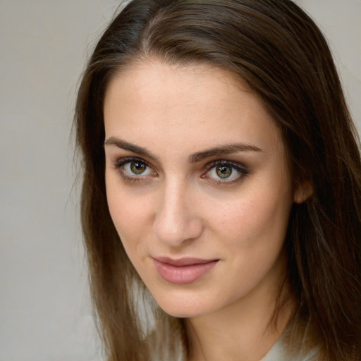 Joyful white young-adult female with long  brown hair and green eyes